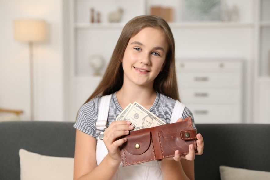 teenager putting money in a wallet