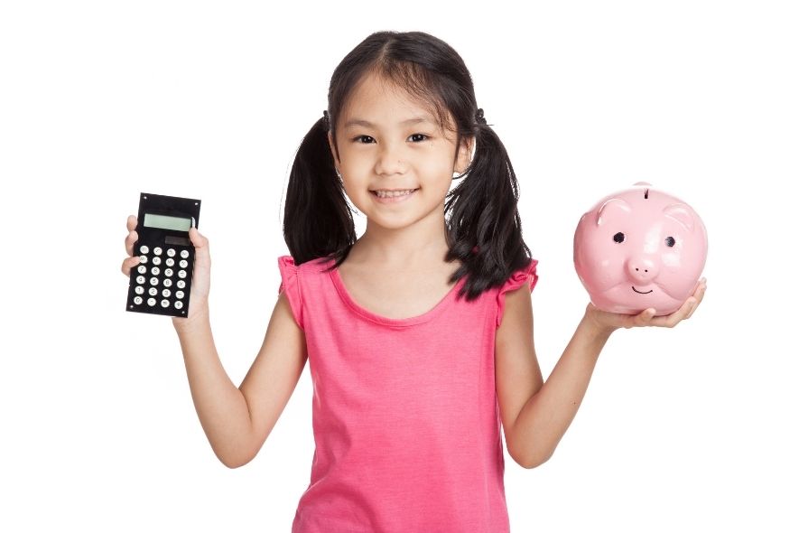 young gilr with piggy bank and calculator