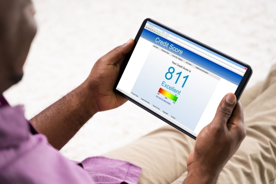 man holding an ipad with credit score on it